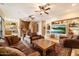 Open living room with a view of the kitchen and features leather sofas and a large TV at 9784 E Miramonte Dr, Scottsdale, AZ 85262