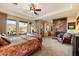 Main bedroom with a stone fireplace, large windows, and a king-size bed at 9784 E Miramonte Dr, Scottsdale, AZ 85262