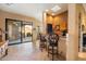 Home bar with granite countertop, custom cabinetry, and two comfortable barstools at 9784 E Miramonte Dr, Scottsdale, AZ 85262