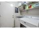 Laundry room with washer, dryer, and storage shelves at 1109 W Seagull Dr, Chandler, AZ 85286