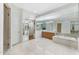 A bright bathroom with a tiled soaking tub, double vanities, and large mirrors at 2 E Biltmore Estates Dr # 115, Phoenix, AZ 85016