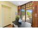 Yellow accented dining space features hardwood floors, a patio view, and access to a private outdoor area at 2 E Biltmore Estates Dr # 115, Phoenix, AZ 85016