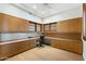 Home office features custom built-in cabinets and shelves for ample storage at 2 E Biltmore Estates Dr # 115, Phoenix, AZ 85016