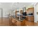 Gourmet kitchen featuring granite countertops, custom cabinetry, stainless steel appliances, and a large center island at 2 E Biltmore Estates Dr # 115, Phoenix, AZ 85016