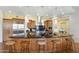 Gourmet kitchen features a large island with seating, stainless steel appliances, and stylish pendant lighting at 2 E Biltmore Estates Dr # 115, Phoenix, AZ 85016