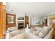 Spacious living room with fireplace, built-in shelving, hardwood floors, and comfortable seating at 2 E Biltmore Estates Dr # 115, Phoenix, AZ 85016