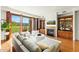 Bright living room with hardwood floors, fireplace, built-ins, and large sliding doors leading to a balcony at 2 E Biltmore Estates Dr # 115, Phoenix, AZ 85016