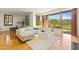 Bright living room featuring an open floor plan, wood floors, and access to outdoor green space at 2 E Biltmore Estates Dr # 115, Phoenix, AZ 85016
