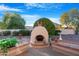 Outdoor kitchen area with a stone oven and seating at 25434 S Michigan Ct, Sun Lakes, AZ 85248