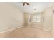 A bedroom with carpeted floors and a ceiling fan is illuminated by natural light streaming in from a window at 4202 E Broadway Rd # 40, Mesa, AZ 85206