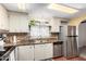 Kitchen with stainless steel appliances and light wood cabinets at 5502 E Baywood Ave, Mesa, AZ 85206