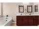 Bathroom with double vanity, large mirrors, and soaking tub at 6843 E Four Peaks Way, Florence, AZ 85132