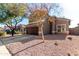 Two-story house with brown garage door and landscaped yard at 6843 E Four Peaks Way, Florence, AZ 85132