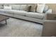 Comfortable living room featuring a plush gray sofa with decorative pillows and a neutral textured rug at 8146 E Wingspan Way, Scottsdale, AZ 85255
