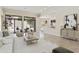 Bright living room featuring travertine floors, neutral decor, and sliding doors to the backyard at 8146 E Wingspan Way, Scottsdale, AZ 85255