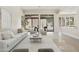 Bright, open living area featuring travertine floors, neutral decor, and sliding doors to the backyard at 8146 E Wingspan Way, Scottsdale, AZ 85255