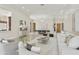 Open concept living and dining area with travertine floors, neutral decor, and a light wood front door at 8146 E Wingspan Way, Scottsdale, AZ 85255