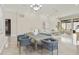 Open living space featuring dining room and living room with neutral decor and travertine floors at 8146 E Wingspan Way, Scottsdale, AZ 85255