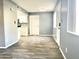 Open living area with wood-look floors and access to kitchen at 1230 N 84Th Pl, Scottsdale, AZ 85257