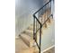 Indoor staircase with carpeted steps and metal railing at 1230 N 84Th Pl, Scottsdale, AZ 85257