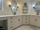 Double vanity bathroom with modern fixtures and a large mirror at 12646 N 17Th Pl, Phoenix, AZ 85022