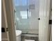 Modern bathroom with a walk-in shower and pebble tile floor at 12646 N 17Th Pl, Phoenix, AZ 85022