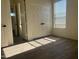 Spacious bedroom with double doors and wood-look tile flooring at 12646 N 17Th Pl, Phoenix, AZ 85022
