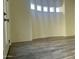 Bright bedroom featuring wood-look tile flooring and a wall of windows at 12646 N 17Th Pl, Phoenix, AZ 85022