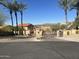 Gated community entrance with palm trees and mountain views at 12646 N 17Th Pl, Phoenix, AZ 85022