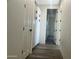 Clean hallway with built-in storage and wood-look tile floors at 12646 N 17Th Pl, Phoenix, AZ 85022