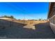 Expansive desert-landscaped backyard with block fence and convenient side-yard access at 142 W Ivanhoe Pl, Chandler, AZ 85225