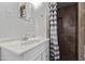 Bathroom with tile shower and marble countertop sink at 142 W Ivanhoe Pl, Chandler, AZ 85225
