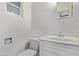 A well lit bathroom with a white vanity and a clean, minimalist design at 142 W Ivanhoe Pl, Chandler, AZ 85225