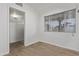 Bright bedroom featuring neutral walls, wood flooring, and a window at 142 W Ivanhoe Pl, Chandler, AZ 85225