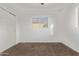Neutral bedroom featuring carpet flooring, bright window, and a closet with folding doors at 142 W Ivanhoe Pl, Chandler, AZ 85225