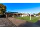 View of the house showcasing a long driveway and manicured lawn at 142 W Ivanhoe Pl, Chandler, AZ 85225