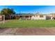 Charming home featuring a lush green lawn and a fountain, complete with modern solar panels at 142 W Ivanhoe Pl, Chandler, AZ 85225