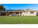 Charming single story home with green lawn, a fountain, and solar panels on the roof at 142 W Ivanhoe Pl, Chandler, AZ 85225