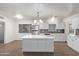 Modern kitchen with stainless steel appliances, mosaic backsplash, and a center island at 142 W Ivanhoe Pl, Chandler, AZ 85225