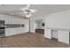 Bright, modern kitchen featuring white cabinets, stainless steel appliances, and wood flooring at 142 W Ivanhoe Pl, Chandler, AZ 85225