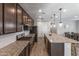 Gourmet kitchen with an expansive granite countertop island and stainless steel appliances at 22459 E Marsh Rd, Queen Creek, AZ 85142