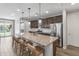 Open kitchen boasts stainless steel appliances, granite countertops and seamless access to the backyard oasis at 22459 E Marsh Rd, Queen Creek, AZ 85142