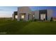 Stunning modern home featuring a manicured lawn and sleek architectural design with contrasting colors at 24825 W Western Star Blvd, Buckeye, AZ 85326