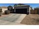 Single-story home with two-car garage, neutral exterior paint, and desert landscaping offers curb appeal at 268 S San Jose Ln, Casa Grande, AZ 85194