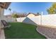 Landscaped backyard with artificial turf and rocking chair at 4110 E La Puente Ave, Phoenix, AZ 85044