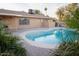 Relaxing kidney-shaped pool in backyard with patio at 4616 W Lane Ave, Glendale, AZ 85301