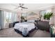 Cozy bedroom with ceiling fan and patterned bedding at 842 E Beverly Rd, Phoenix, AZ 85042