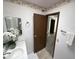 Bathroom with tiled floor and view to bedroom with gray carpet at 11012 W Thunderbird W Blvd, Sun City, AZ 85351
