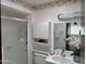 Bathroom featuring white vanity, shower, butterfly wallpaper border, and updated fixtures at 11012 W Thunderbird W Blvd, Sun City, AZ 85351