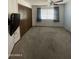 Bedroom with neutral carpet, closet, and window for natural light at 11012 W Thunderbird W Blvd, Sun City, AZ 85351